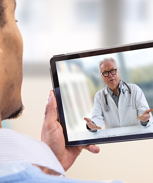 man on video call with doctor