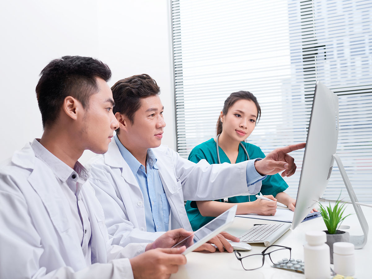Doctors looking at computer