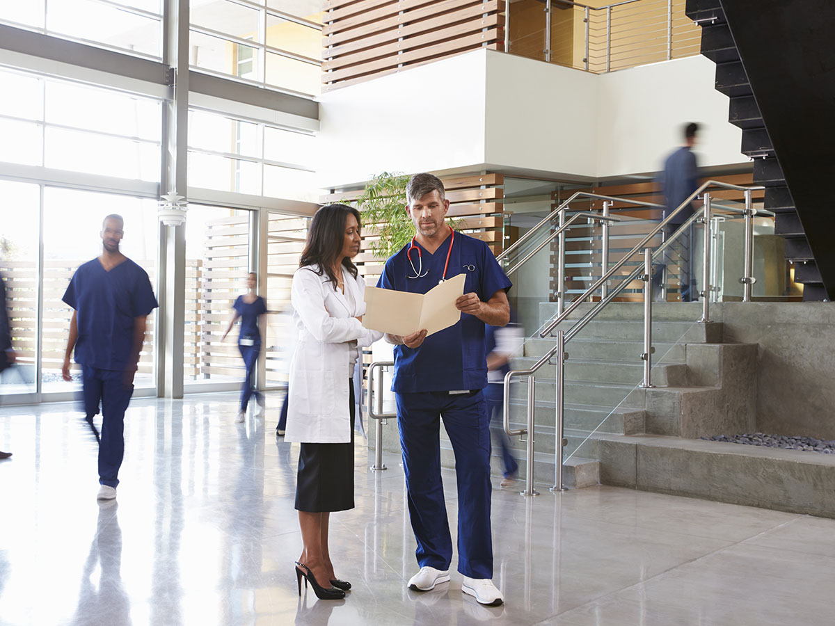 Doctor talking to nurse with a file