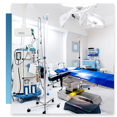 A surgical room with a bed and equipment