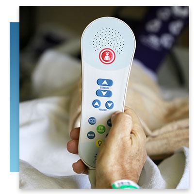 A hospital bed remote with a nurse call button