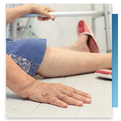An elderly patient sitting on the floor after a fall