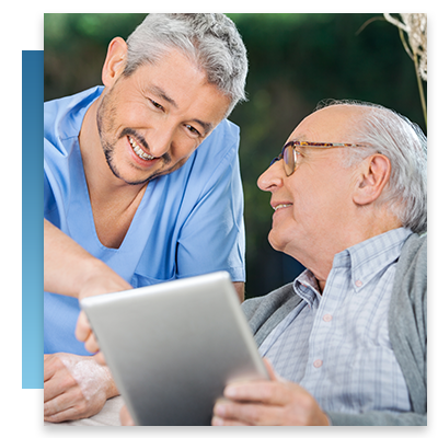 A resident and assitant looking at a tablet and smiling
