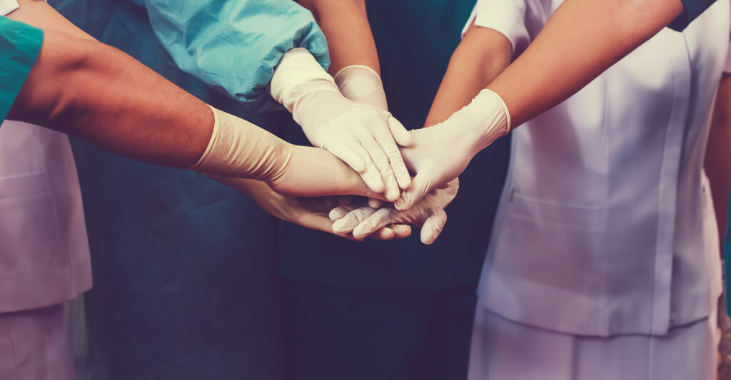 Nurses hands together in a handshake