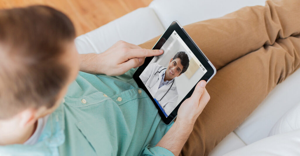 A young man speaking with a doctor on a video call on his tablet
