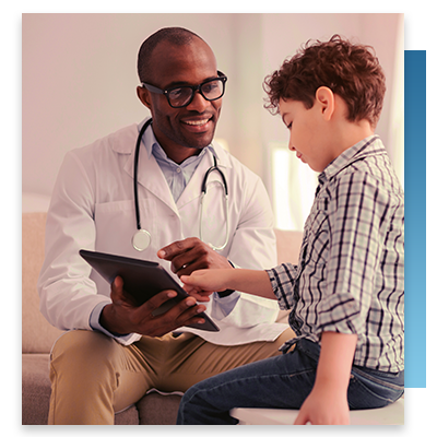 A doctor showing a young patient a tablet