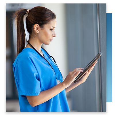 A nurse looking up something on a tablet