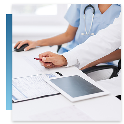 A doctor and nurse using a tablet and a computer