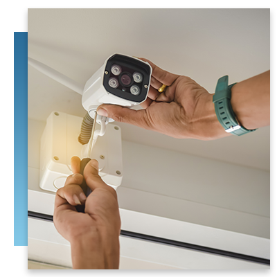 A technician repairing a security camera