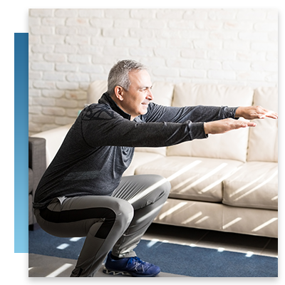 Senior in his room stretching by the couch