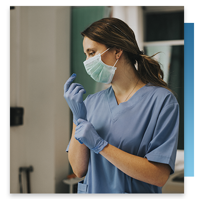 A nurse putting on gloves