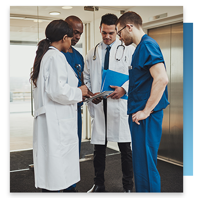A team of doctos and nurses gathering in a hospital hallway