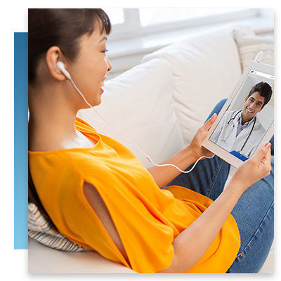 A woman sitting on her couch speaking with a doctor on her tablet