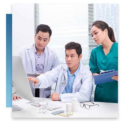 A doctor and two nurses by a computer