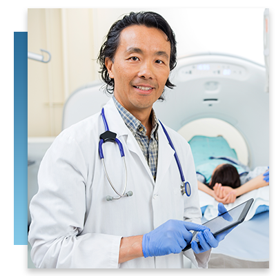 A doctor staniding by an MRI machine with a tablet in his hands