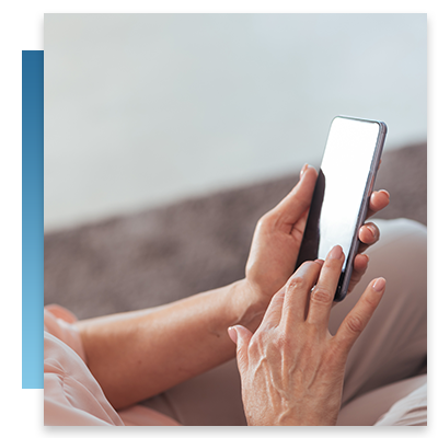 A elderly woman holding up her phone