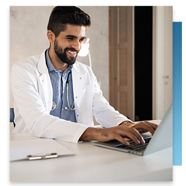 A doctor using his laptop in his office