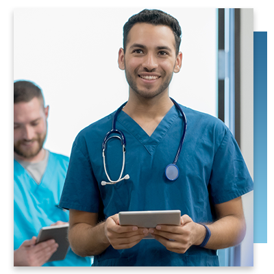 A male nurse holding a tablet smiling