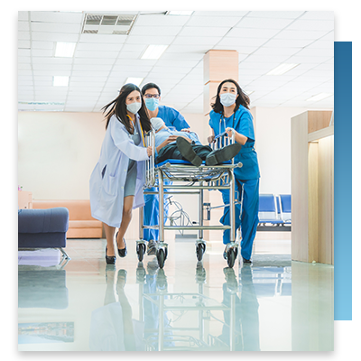 Hospital nurses and a doctor hurrying a person through the emergency room