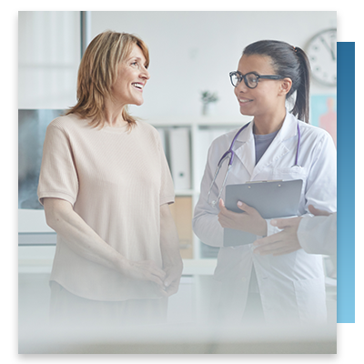 A doctor and patient smiling while speaking to each other