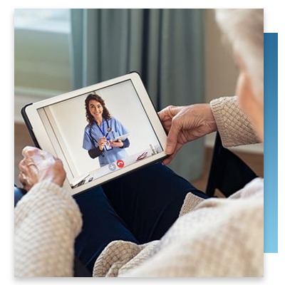 A senior woman using a tablet to talki to a nurse