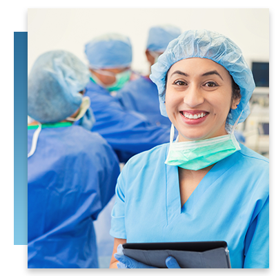 A nurse smiling while she holds a tablet