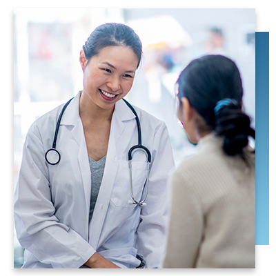 An Asian doctor speaking to a young patient