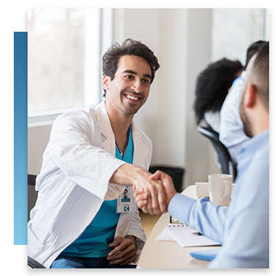 A doctor shaking hands with a businessman at a meeting