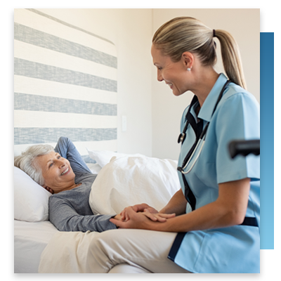 A nurse sitting with a patient while they wake up 