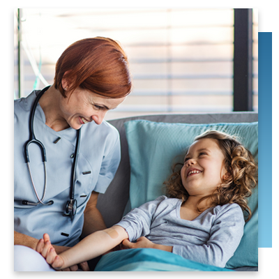 A doctor laughing with a young patient