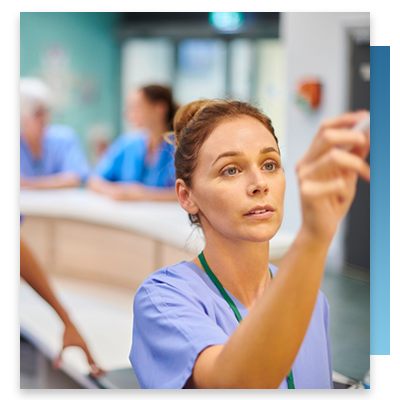 A nurse checking an assignment board