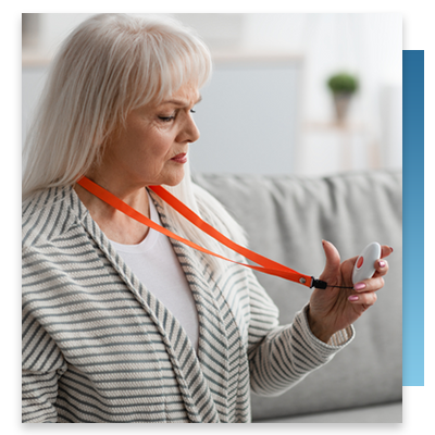A patient looking at her nurse call button necklace