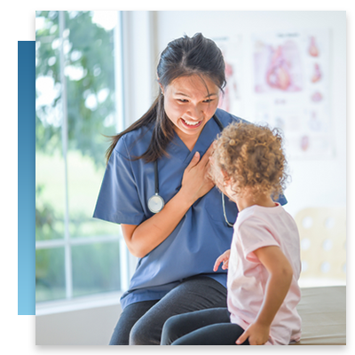 A nurse smiling while talking to a young patient