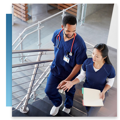 Two nurses going up stairs at a hospital