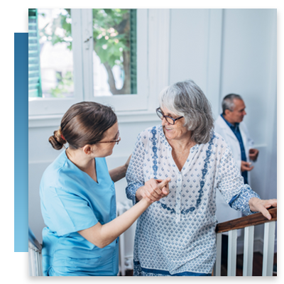 A nurse helping an elderly woman up the stairs