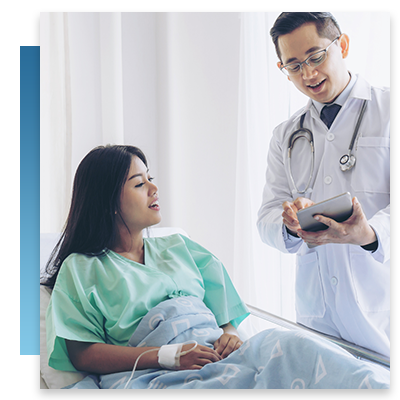 A doctor talking to a patient while they look at a tablet