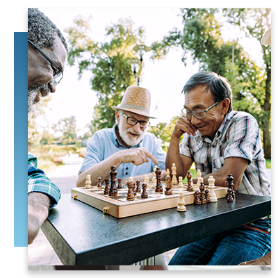 A group of elderly men at a senior center playing chess