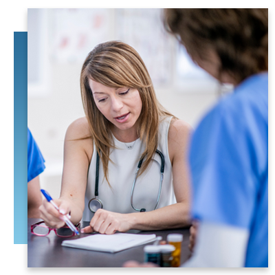 A doctor looking at a report while in a serious meeting
