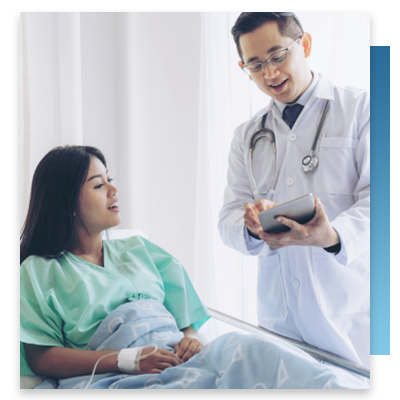 A doctor explaining treatment to a patient in a hospital bed