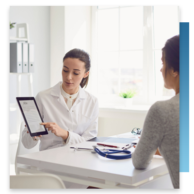 A doctor with a tablet going over prescriptions with a patient