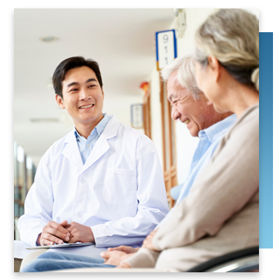 A doctor speaking with two older patients