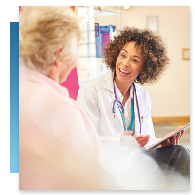 A doctor smiling while talking to a patient