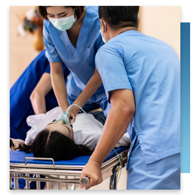 Nurses moving a patient on a gurney 