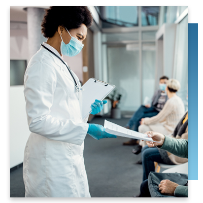 Hospital staff handing out paperwork to waiting patients