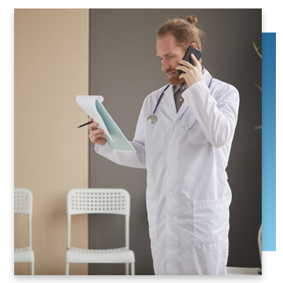 A doctor looking at a chart while on the phone