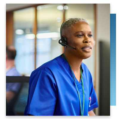 A nurse at a station on a wireless headset