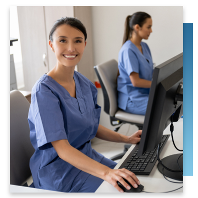 A nurse at a station smiling