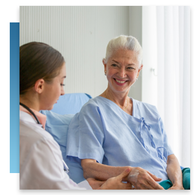 A happy patient sitting in a hospital bed