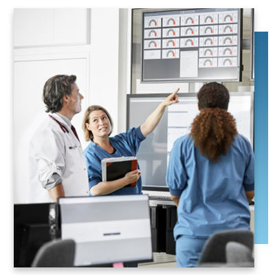 Nurses looking at screens in hospital control room