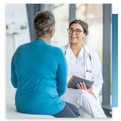 A patient having a conversation with a doctor who is holding a tablet